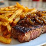 Ribeye Steak with Caramelized Onions and Crispy Fries