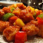 Close-up of a Cheesy Loaded Zucchini Bake with chunks of zucchini, cheese, and red and green peppers.
