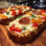 Two slices of Ultimate Texas Toast Pizza topped with melted cheese, pepperoni, and colorful bell peppers on a wooden board.