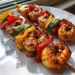 Close-up of grilled shrimp skewers with bell peppers and zucchini, perfect for Memorial Day.