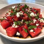 A refreshing watermelon feta salad with fresh mint and a balsamic glaze, perfect for Memorial Day.