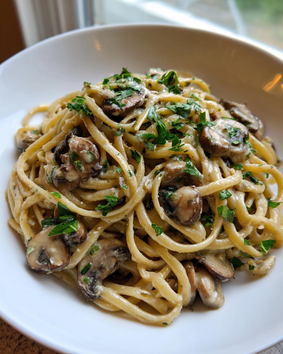 Close-up van een kom met romige Miso Champignon Pasta, gegarneerd met verse peterselie.